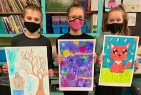 Cayden Cavanaugh, Vada Hunsley and Kayla Hamilton from Chiganois Elementary School with their drawings for the banners.