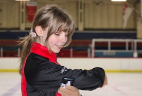 Figure skater Leela Dietert, who lives with Type 1 diabetes, checks her blood sugar using a flash glucose monitor during a recent practice with the Greenwood Skating Club.