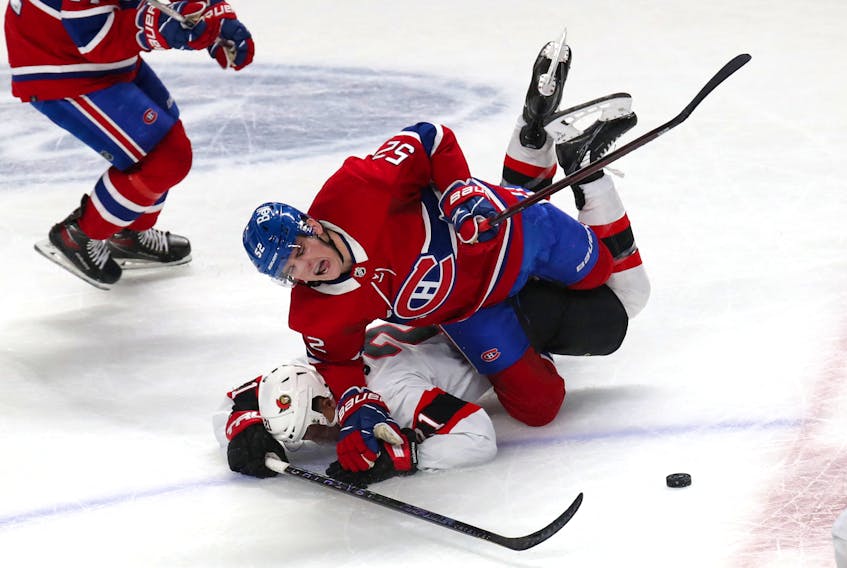 Apr 5, 2022; Montreal, Quebec, CAN; Montreal Canadiens defenseman Justin Barron (52) falls on Ottawa Senators right wing Mathieu Joseph (21) during the third period at Bell Centre. Mandatory Credit: Jean-Yves Ahern-USA TODAY Sports  Montreal Canadiens defenceman Justin Barron (52) and Ottawa Senators winger Mathieu Joseph get tangled up during an April 5 NHL game at the Bell Centre in Montreal. - Jean-Yves Ahern-USA TODAY Sports