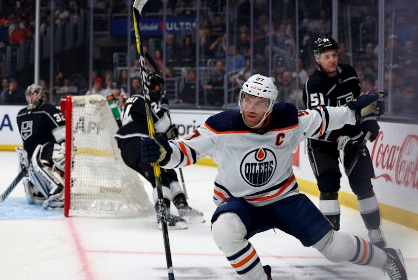Connor McDavid (97) of the Edmonton Oilers celebrates his goal in front of Troy Stecher (51), Phillip Danault (24) and Jonathan Quick (32) of the Los Angeles Kings, to take a 1-0 lead at Crypto.com Arena on April 07, 2022, in Los Angeles, Calif. 