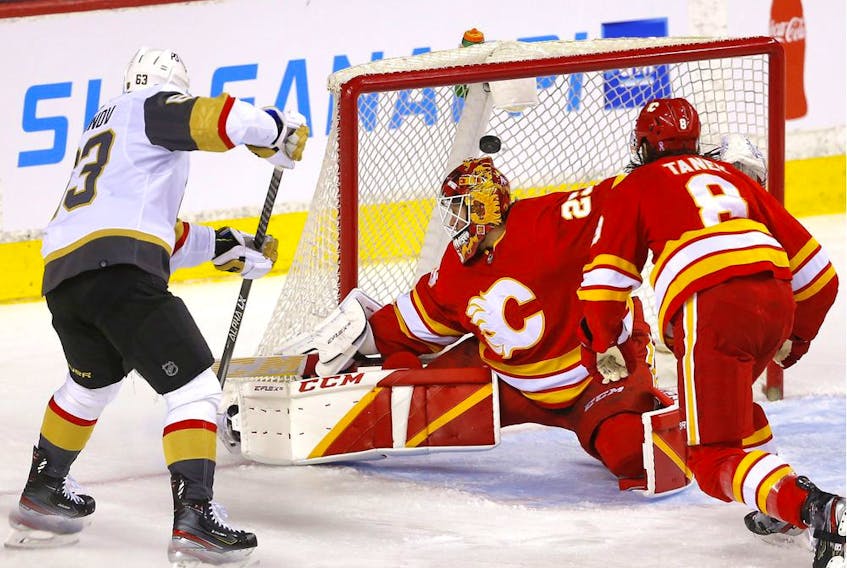 Calgary Flames goalie Jacob Markstrom is scored on by Vegas Golden Knights Evgenii Dadonov in second period NHL action at the Scotiabank Saddledome in Calgary on Thursday, April 14, 2022. 