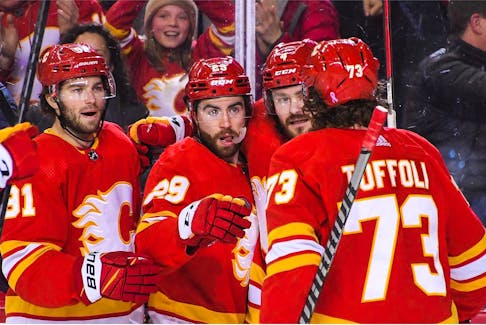 Dillon Dube #29 (C) of the Calgary Flames celebrates with his teammates after scoring against the Vegas Golden Knights during the first period of an NHL game at Scotiabank Saddledome on April 14, 2022 in Calgary, Alberta, Canada.