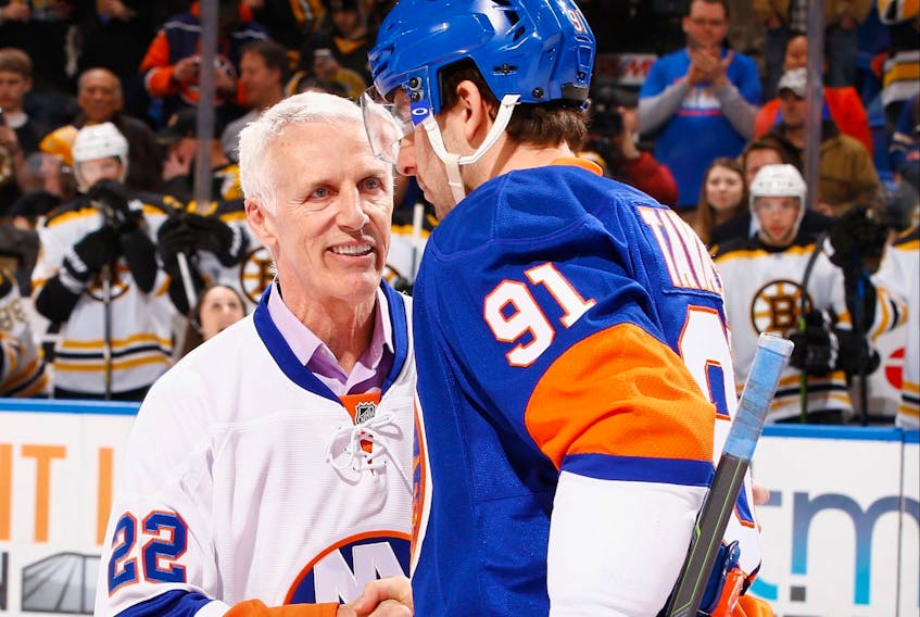 In this 2015 photo, former New York Islander Mike Bossy greets John Tavares prior to the game during Mike Bossy Tribute Night at the Nassau Veterans Memorial Coliseum in Uniondale, New York.  