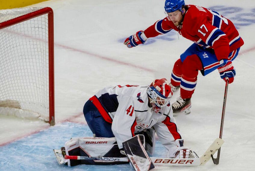 Washington Capitals goalie Vitek Vanecek smothers the puck as Canadiens' Josh Anderson (17) looks for a rebound in Montreal on Saturday, April 16, 2022.

