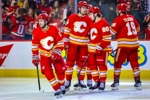  Calgary, Alberta, CAN; Calgary Flames left wing Johnny Gaudreau (13) celebrates his goal with teammates against the Arizona Coyotes during the third period at Scotiabank Saddledome. 