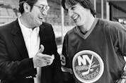  In this March 17, 1982 file photo, New York Islanders coach Al Arbour, left, talks with his top scorer, Mike Bossy, during a break in practice in Denver.