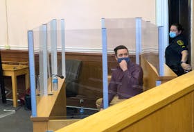 Justin Greenslade, 29, looks toward supporters in the gallery in Courtroom 4 in Newfoundland and Labrador Supreme Court in St. John's Monday, April 18.