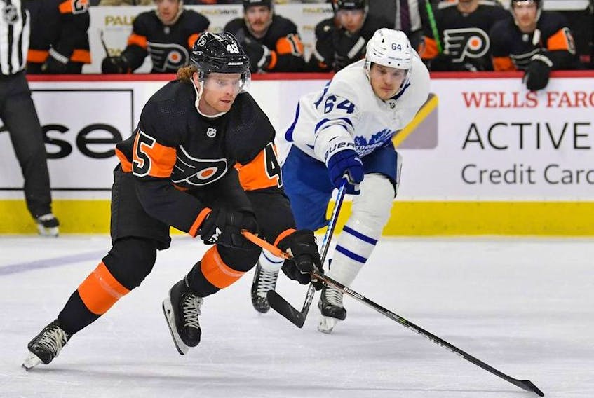 Philadelphia Flyers defenseman Cam York controls the puck against Toronto Maple Leafs center David Kampf during the first period at Wells Fargo Center. 