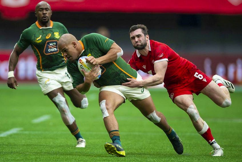  Canada’s Alex Russell, right, closes in on South Africa’s Zain Davids in the HSBC World rugby Sevens Series at BC Place Stadium in Vancouver, BC Saturday, April 16, 2022.