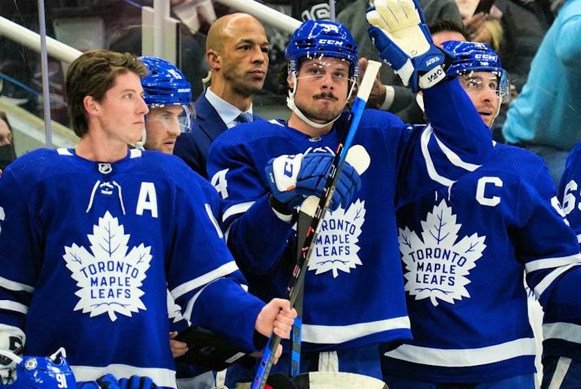Apr 9, 2022; Toronto, Ontario, CAN; Toronto Maple Leafs forward Auston Matthews (middle) acknowledges a tribute by fans after setting a new Maple Leafs single season record for goals during a break in the action against the Montreal Canadiens at Scotiabank Arena.  