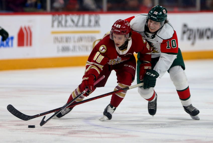 Halifax Mooseheads Mathieu Cataford tries to konc the puck away from Acadie-Bathurst Titan Miguel Tourigny during QMJHL action in Halifax Tuesday April 12, 2022.

TIM KROCHAK PHOTO