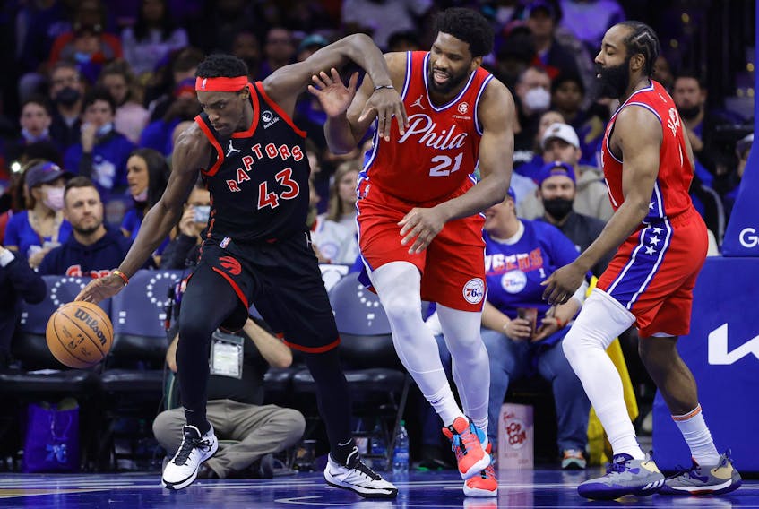 Pascal Siakam #43 of the Toronto Raptors and Joel Embiid #21 of the Philadelphia 76ers challenge for the ball during the fourth quarter of Game Two of the Eastern Conference First Round at Wells Fargo Center in Philadelphia, Pennsylvania.