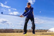 Colby Ruff takes a shot at Fox Hollow Golf Course in Calgary on Friday, April 1, 2022. Golf courses around the city are opening for the season as spring approaches. 
Steven Wilhelm/Postmedia