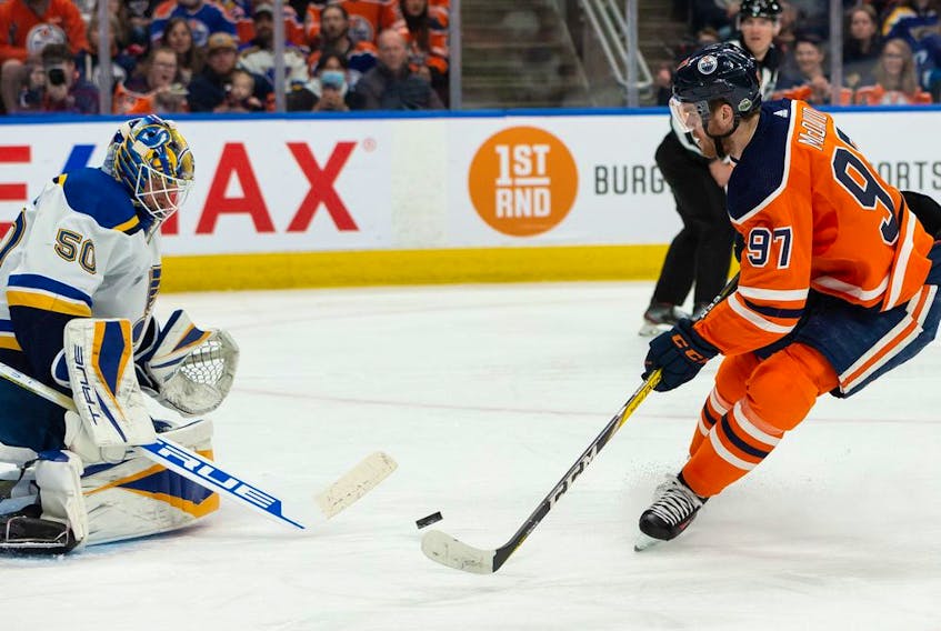 Edmonton Oilers' Connor McDavid (97) is stopped by St. Louis Blues' goaltender Jordan Binnington (50) during first period NHL action at Rogers Place in Edmonton, on Friday, April 1, 2022. 