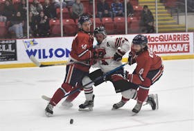 Truro Bearcats forward Gavin Hart tries to split Valley Wildcats defencemen Keigan Casey, left, and Philippe Casault during Game 7 of their Maritime Junior Hockey League semifinal April 20 at the Rath Eastlink Community Centre in Truro.