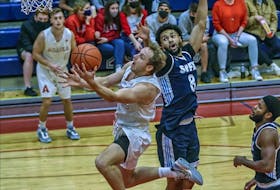 St. Francis Xavier's David Muenkat tries to block Acadia's Rowan Power during an Atlantic university basketball game on Nov. 5. Muenkat was selected first overall in the Canadian Elite Basketball League U Sports draft on Tuesday. - CONTRIBUTED