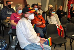 Gay rights activist Eric Smith (right) sits quietly with a handful of pride flags as he watches the proceedings at the April 11 meeting  of Barrington Municipal Council. KATHY JOHNSON
