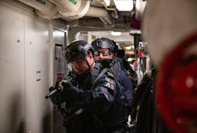 Members of HMCS Halifax's naval boarding party clear through the decks of the ship as they practice their close quarter drills on March 30.