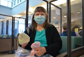 Janet Card displays some of the baby hats she knits and donates to the Valley Regional Hospital Foundation to give to newborns in the Valley Regional Hospital’s women and children’s ward. Card donated 100 hats on April 13. KIRK STARRATT