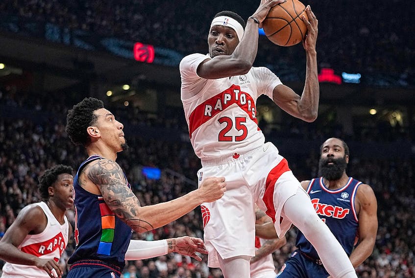 Toronto Raptors forward Chris Boucher (25) rebounds the ball against Philadelphia 76ers forward Danny Green (14) during Game 3 of the first round of the 2022 NBA playoffs at Scotiabank Arena. 