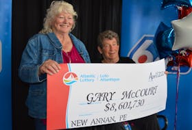 Gary McCourt, right, and his wife, Joy, accept a cheque for more than $8.6 million from Atlantic Lottery in Charlottetown on April 22.