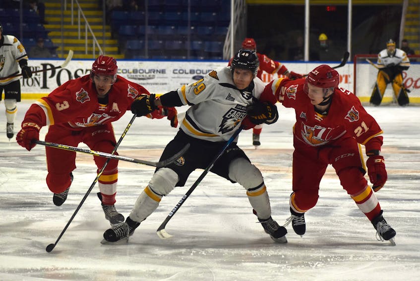 Ivan Ivan of the Cape Breton Eagles, middle,  works his way through Baie-Comeau Drakkar teammates Etienne Arseneau, left, and Niks Fenenko during Quebec Major Junior Hockey League action at Centre 200 on Thursday. Cape Breton won the game 5-2. The Eagles will host the Rimouski Océanic at 3 p.m. on Sunday. JEREMY FRASER/CAPE BRETON POST