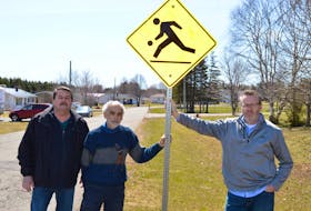 Some residents of the Highfield Heights subdivision in Charlottetown, including, from left, Barry Herrell, David Kay and Gavin Shipley, say a new subdivision adjacent to theirs will increase traffic in their neighbourhood and put children at risk.