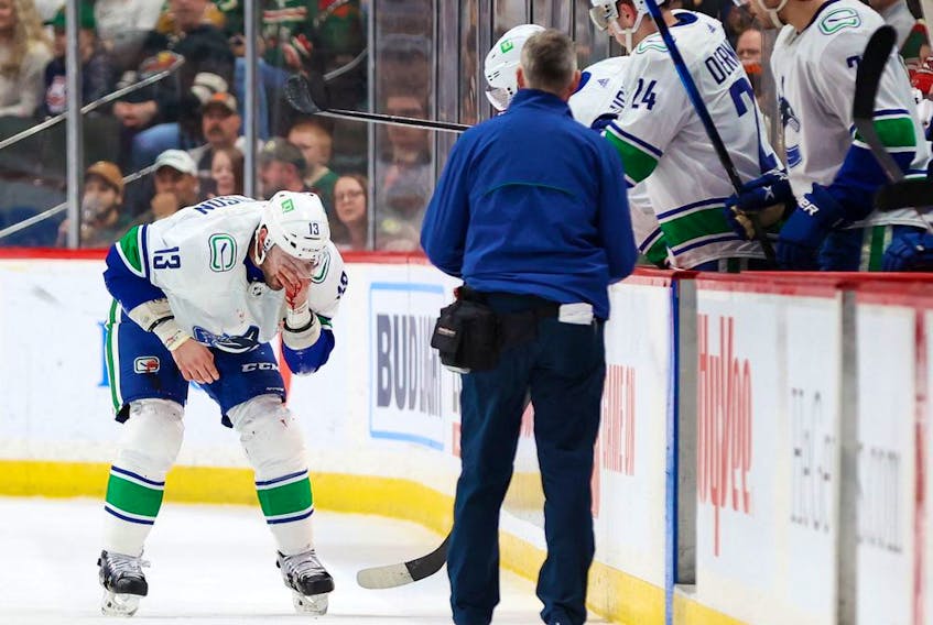  Vancouver Canucks right wing Brad Richardson (13) leaves the ice after receiving a high stick by Minnesota Wild left wing Kirill Kaprizov during the first period at Xcel Energy Center. Canucks coach Bruce Boudreau said that Richardson broke his nose.