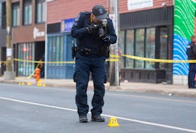 A Halifax Regional Police officer takes photos at a homicide scene on Gottingen St. on Friday, March 18, 2022. Police responded to a weapons call and found a man in his 20s who was shot. He later died in the hospital from his injuries.
Ryan Taplin - The Chronicle Herald