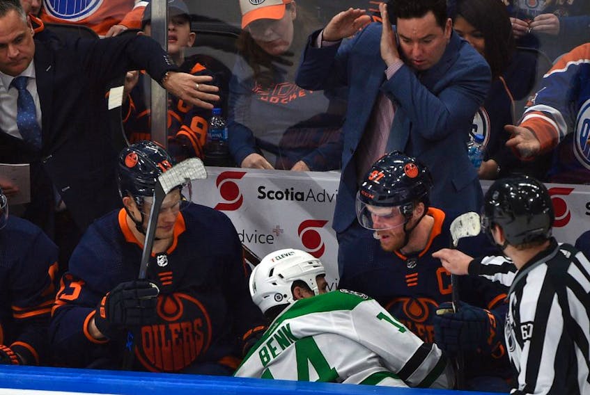 Edmonton Oilers Connor McDavid (97) eyes Dallas Stars Jamie Benn (14) after he was hit and ended up in the Oilers bench during NHL action at Rogers Place in Edmonton, April 20, 2022. 