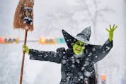 Cathy McLeod, aka Kraft Zombie, dressed as the Wicked Witch of the West from Wizard of Oz poses for a photo at the Parade of Wonders as cosplayers brave the heavy snow to participate in Calgary Comic and Entertainment Expo kick-off parade  on Friday, April 22, 2022. 