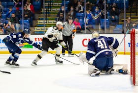 Charlottetown Islanders forward Dawson Stairs, 25, protects the puck from the Sherbrooke Phoenix’s David Spacek, 18, as he moves in on goaltender Jakob Robillard. The action took place in a Quebec Major Junior Hockey League game at Eastlink Centre in Charlottetown on April 22. The Phoenix won the game 6-2. Darrell Theriault Photo/Charlottetown Islanders