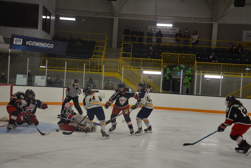 Northern Subway Selects’ Kenzie Greencorn (11) pounces on a puck against  the Moncton Edza West’s Reds  in the gold-medal game of the   Atlantic Under-18 AAA Female hockey championship in Tyne Valley, P.E.I., on Sunday.  
