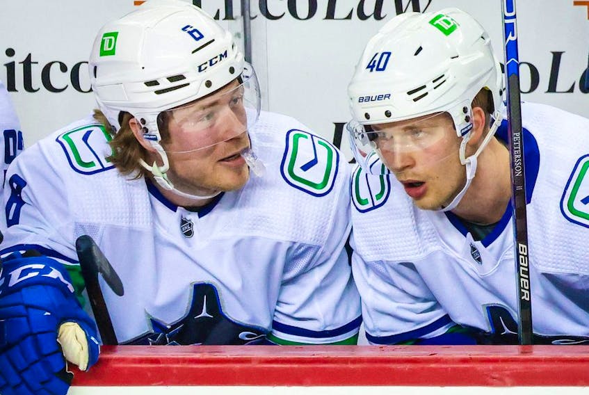 Apr 23, 2022; Calgary, Alberta, CAN; Vancouver Canucks right wing Brock Boeser (6) and center Elias Pettersson (40) on the bench during the first period against the Calgary Flames at Scotiabank Saddledome. 