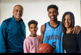 Dartmouth's Kellen Tynes poses in a University of Maine jersey with members of his family after announcing on Sunday he is transferring from Montan State University. - Contributed