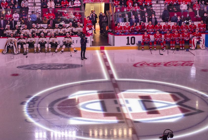 Players from the Boston Bruins and Montreal Canadiens watch a video in memory of Guy Lafleur at the Bell Centre prior to game between the Montreal Canadiens and Boston Bruins in Montreal on April 24, 2022.