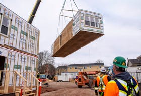 Crews work on the construction of a new modular apartment building at 203 Fitzroy St. 