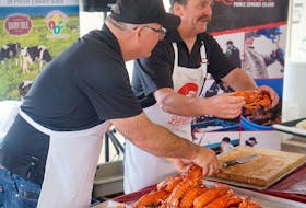 Two Island fisherman, including Kenneth LeClair, right, serving lobster during the lobster supper during the Summerside Lobster Carnival. Oliver Childs photo.