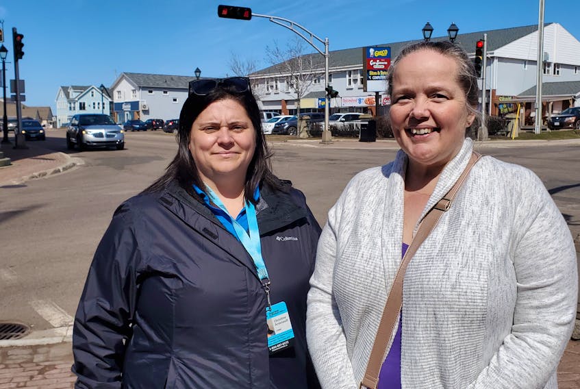 Christine Arsenault, left, orientation and mobility specialist with Vision Loss Rehabilitation Canada, and Jennifer Sanderson, a Summerside resident with vision impairment, on Water Street in Summerside. The city recently completed a review of its pedestrian pushbuttons in an effort to improve safety for people with vision impairment like Sanderson. 