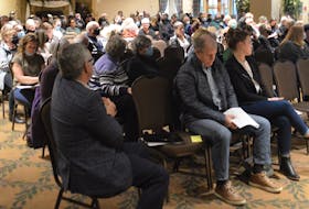 MNP's Sonny MacDougall, left, looks over the crowd of residents attending the Village of Baddeck's electors' meeting at the Inverary Resort on Monday night. IAN NATHANSON/CAPE BRETON POST