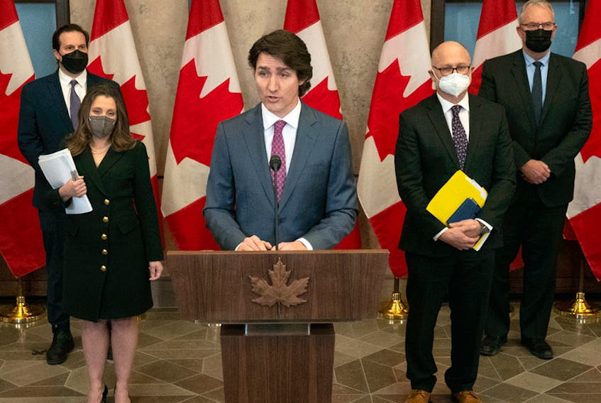 Public Safety Minister Marco Mendicino, Deputy Prime Minister Chrystia Freeland, Justice Minister David Lametti and Emergency Preparedness Minister Bill Blair stand behind Prime Minister Justin Trudeau as he announces the Emergencies Act will be invoked to deal with protests in Ottawa, February 14, 2022.