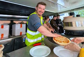 Trevor MacDonald serves a pizza at a food truck near Medyka, Poland. He is volunteering with with Siobhans Trust, a Scottish charity that serves hot meals to refugees from neighbouring Ukraine. Contributed/Trevor MacDonald
