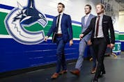  Brandon Sutter, Thatcher Demko and Brock Boeser of the Vancouver Canucks walk to the dressing room before their NHL game against the Detroit Red Wings at Rogers Arena October 15, 2019 in Vancouver.