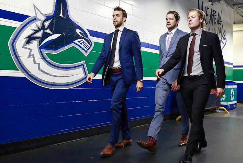  Brandon Sutter, Thatcher Demko and Brock Boeser of the Vancouver Canucks walk to the dressing room before their NHL game against the Detroit Red Wings at Rogers Arena October 15, 2019 in Vancouver.
