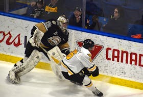 Charlottetown Islanders goaltender Oliver Satny plays the puck behind the net as he's pressured by Carter McCluskey of the Cape Breton Eagles during Quebec Major Junior Hockey League action at Centre 200 on April 26. Charlottetown won the game 5-3.