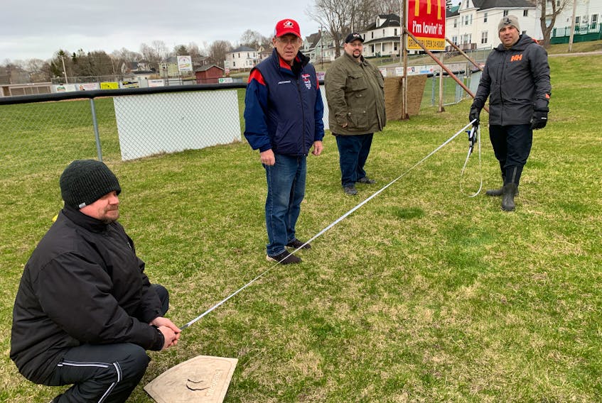 Amherst Little League Baseball officials (from left) Paul Terrio, Terry ‘Mouser’ McManaman, Tim Larade and Mike LeBlanc measure off space for a new accessible t-ball field at the little league complex in Amherst. Little league has received $70,000 in funding from the Toronto Blue Jays’ Jays Care Foundation through its Field of Dreams program.