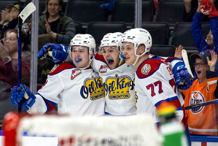 The Edmonton Oil Kings' Carson Golder (9), Jaxsen Wiebe (43) and Jakub Demek (77) celebrate a goal against the Lethbridge Hurricanes during second period WHL playoff action at Rogers Place in Edmonton, Saturday April 23, 2022. 