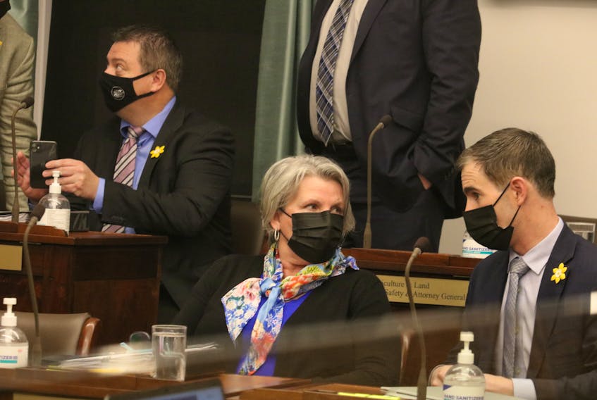 Finance Minister Darlene Compton speaks to MLA Sidney MacEwen in the P.E.I. legislature. Compton fielded questions about a $500 trailer hitch that appeared on her public disclosure statements. 