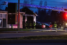 Firefighters from the Charlottetown Fire Department were assessing the damage after a fire destroyed most of a Brackley Point Road auto repair shop April 28. Multiple fire fighters hauled a burnt car out of the garage of the shop, while others sprayed down hot spots around the building.