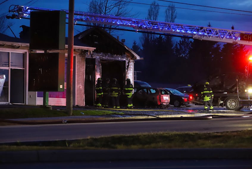 Firefighters from the Charlottetown Fire Department were assessing the damage after a fire destroyed most of a Brackley Point Road auto repair shop April 28. Multiple fire fighters hauled a burnt car out of the garage of the shop, while others sprayed down hot spots around the building.